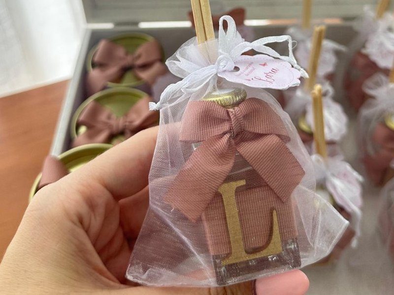 Difusor em saquinho de organza branca com la�o rose e uma inicial L dourada aplicada na frente